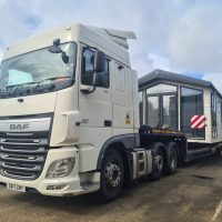 White truck with static caravan on the flatbed